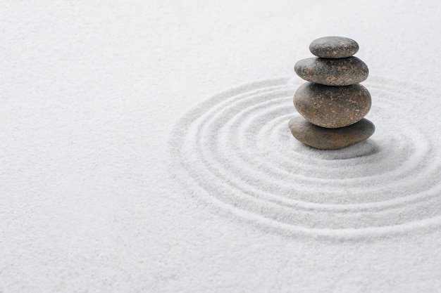 Stacked zen stones sand background art of balance concept