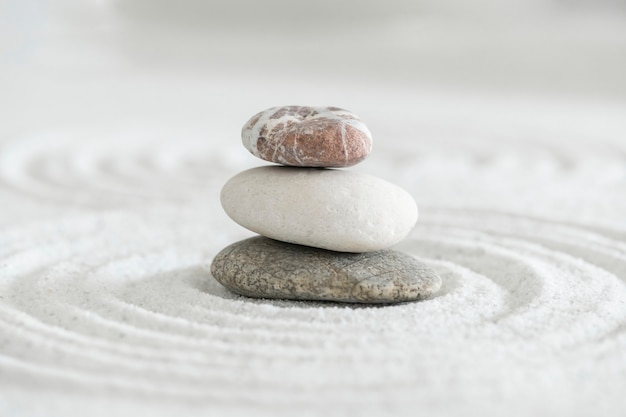 Free photo stacked zen stones sand background art of balance concept