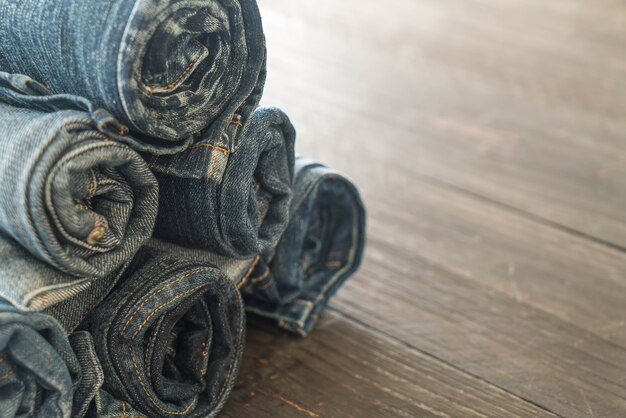 stacks of jeans clothing on wood