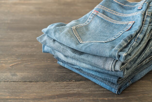 stacks of jeans clothing on wood