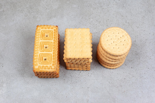 Stacks of various biscuits on marble background. High quality photo