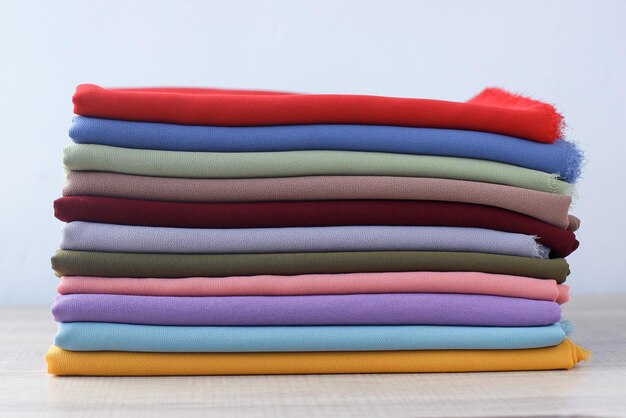 Stacks of various folded colorful ceruty fabrics  fabric background concept