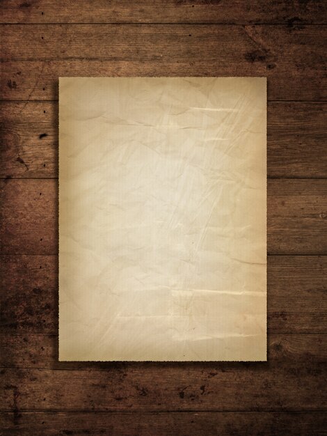 Stained old paper on a grunge wood background