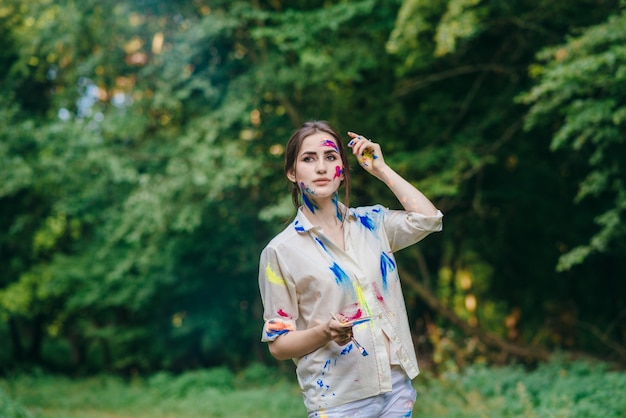 Stained painting woman walking through a field with trees