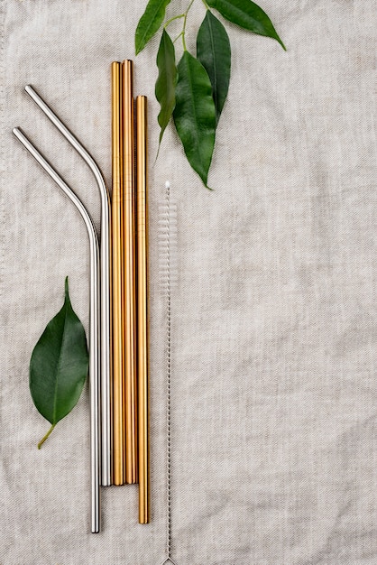 Free photo stainless metallic straws and leaf