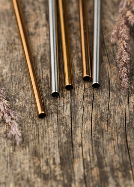 Stainless metallic straws on wooden background