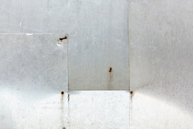 Free photo stainless steel slabs with rusted nails