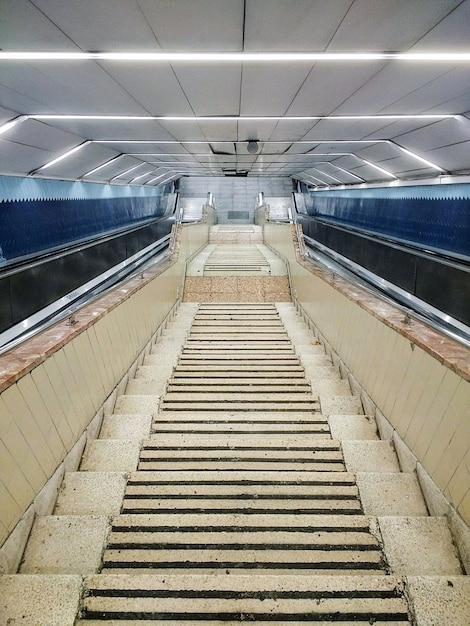 Stairs made of white stone going down through the building