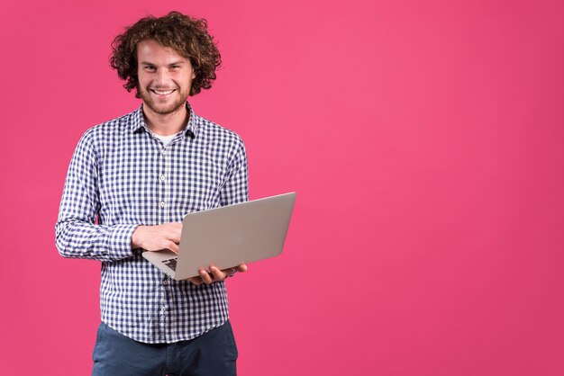 Standing man using laptop