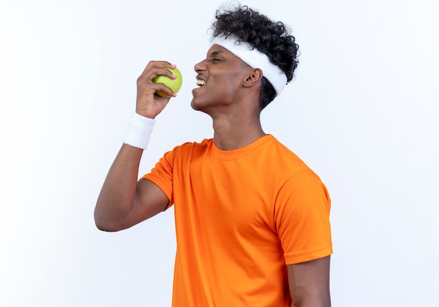 Standing in profile view young sporty man wearing headband