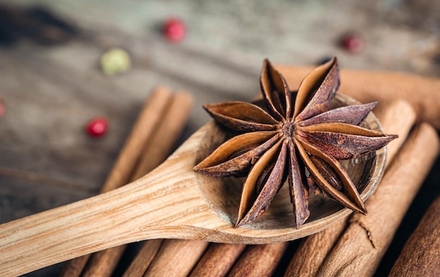 Star anise and cinnamon sticks closeup on a wooden background