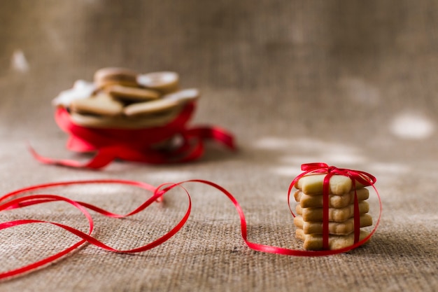 Free photo star cookies with red ribbon on table