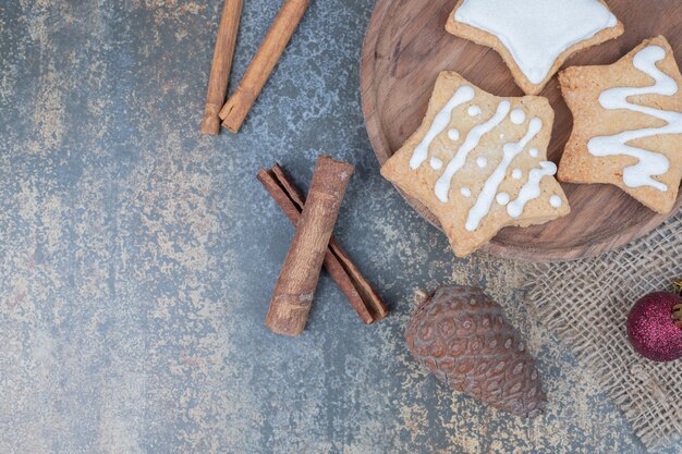 Star shaped gingerbread cookies on plate with Christmas balls. High quality photo