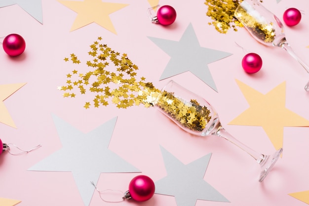 Free photo star spangles scattered from glasses with shiny baubles