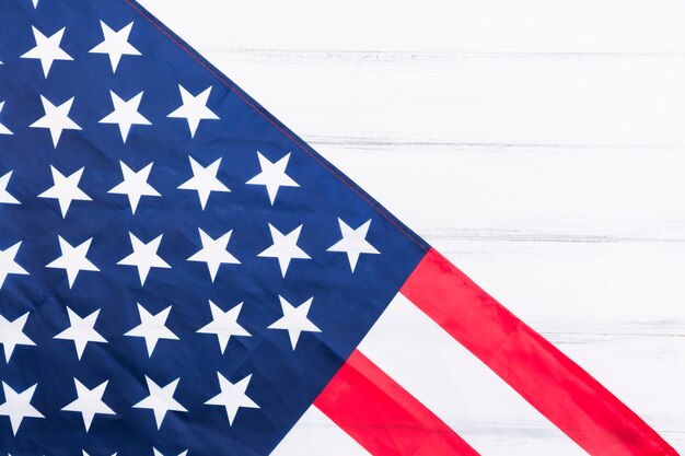 Stars and stripes of American flag on white surface