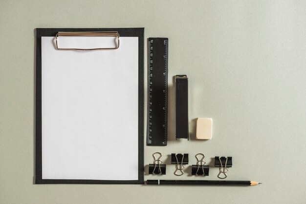 Stationeries with clipboard on plain background