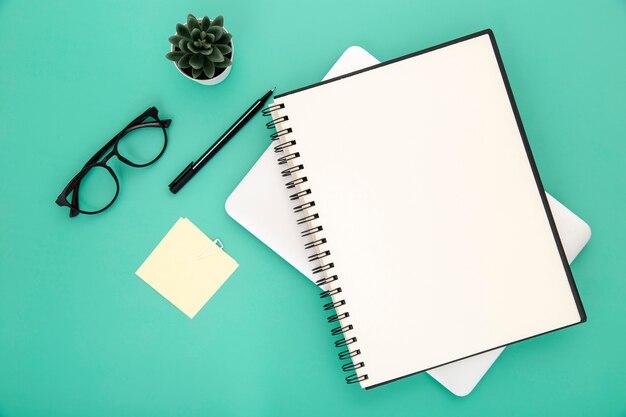 Stationery arrangement on green background