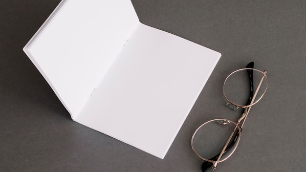 Free photo stationery concept with paper and glasses