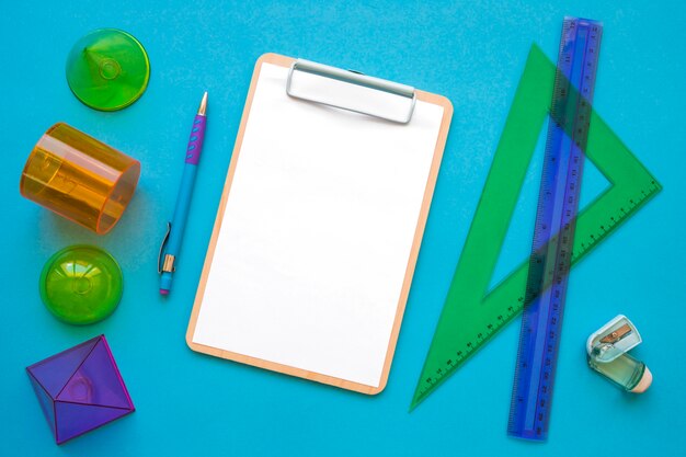 Stationery and geometric shapes near clipboard