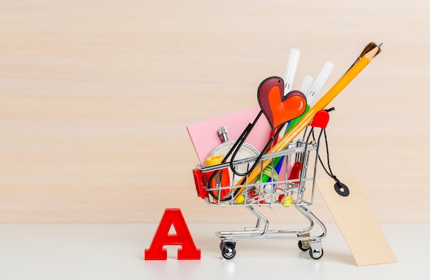 Free photo stationery items in shopping trolley at left side