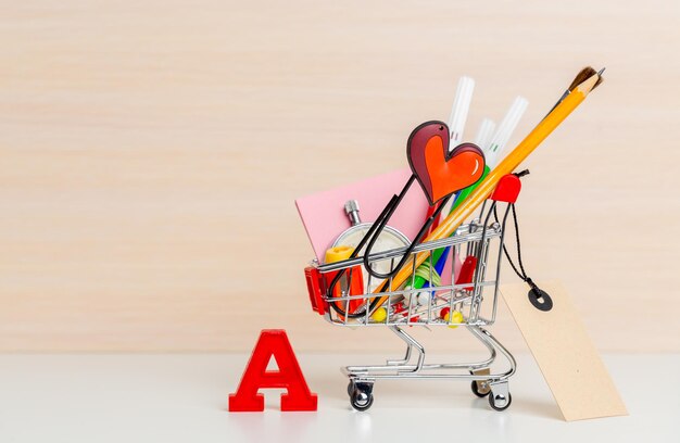 Stationery items in shopping trolley at left side
