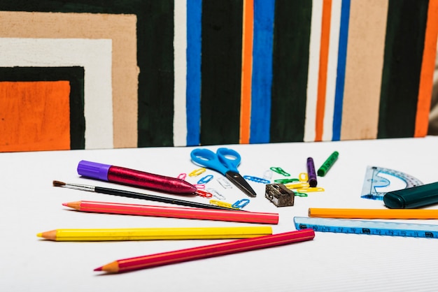 Stationery lying near abstract painting