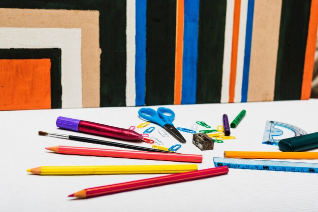 Stationery lying near abstract painting