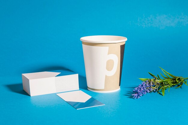 Stationery mockup with cards, cup and flower