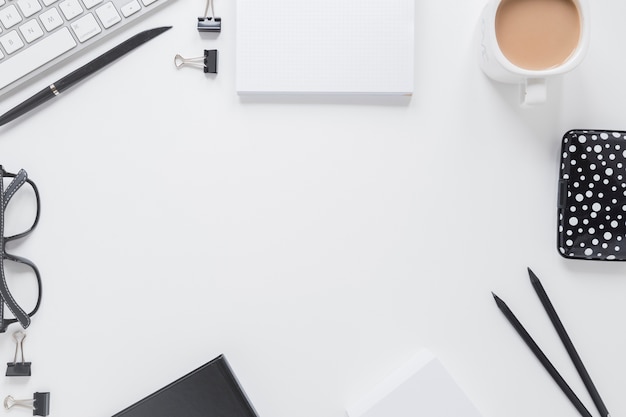 Stationery near glasses and keyboard