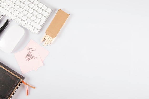 Stationery near keyboard and mouse