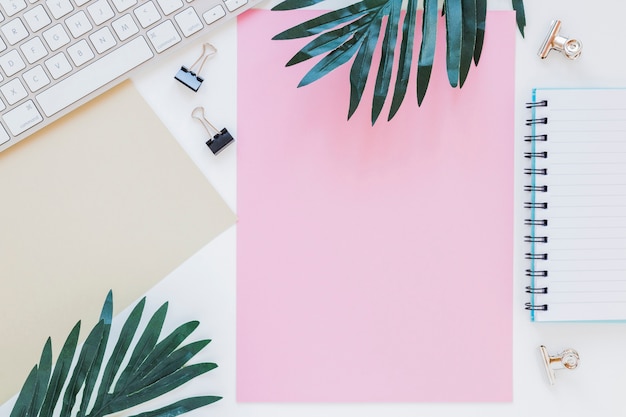 Stationery near keyboard and palm trees