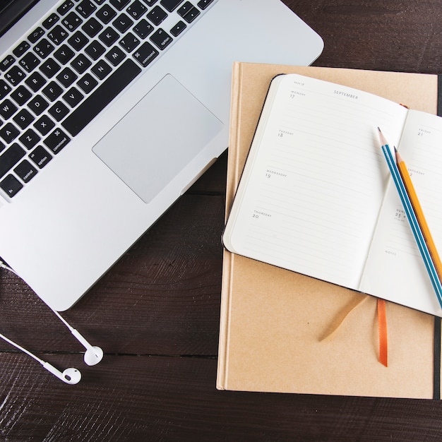 Stationery near laptop and earphones