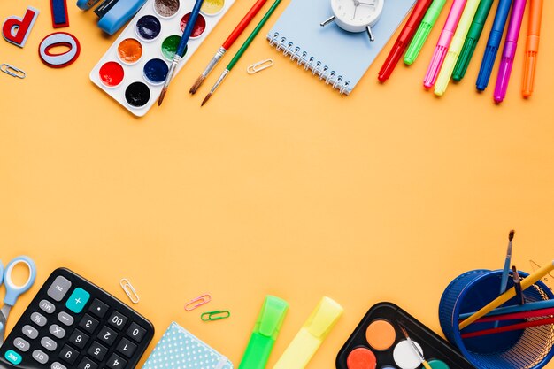 Stationery and office implements on orange table