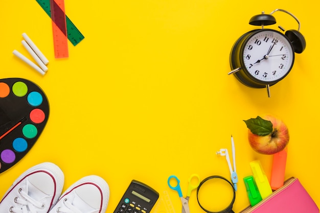 Stationery and sneakers laid in circle