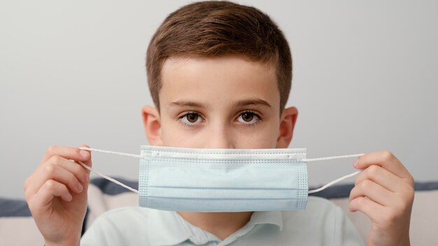 Stay indoors kid wearing medical mask