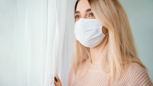 Stay indoors woman wearing white medical mask