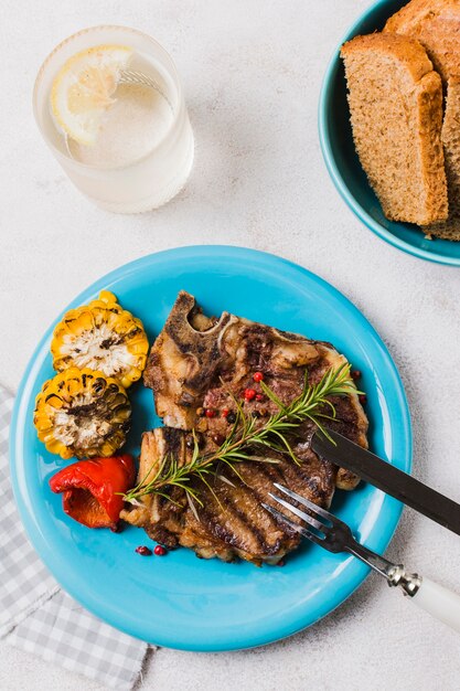 Steak on plate with vegetables and drink