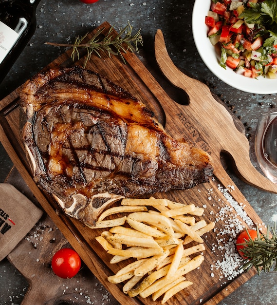 Steak served with french fries and salad