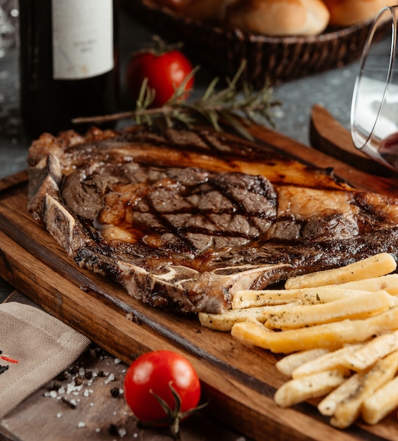 Steak served with french fries and tomatoes