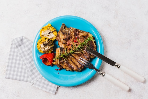 Foto gratuita bistecca con verdure sul piatto con posate