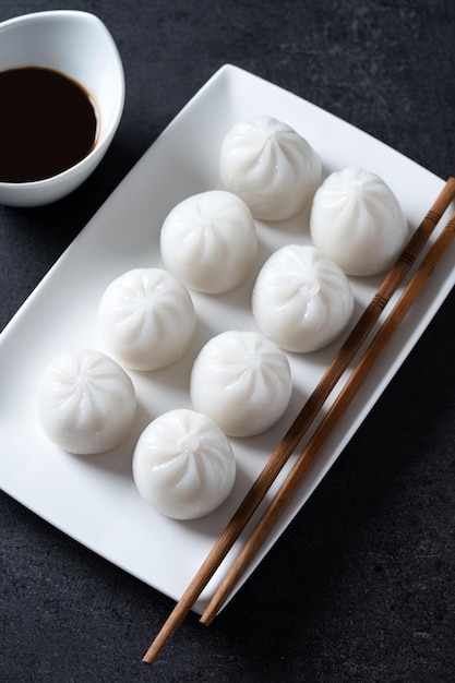 Steamed dumplings on black slate background