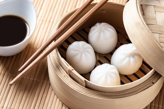 Steamed dumplings and soy sauce isolated on white background