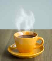 Free photo steaming coffee cup on table