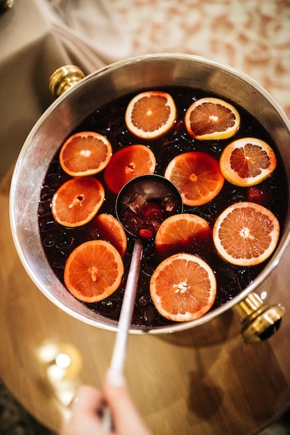 Free photo steel bowl with a punch stands on wooden table