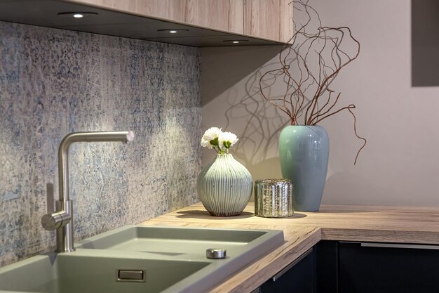 Steel faucet in the kitchen in the interior