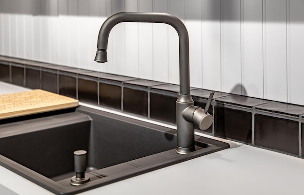 Steel faucet in the kitchen in the interior