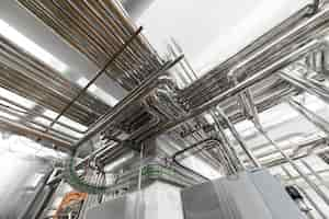 Free photo steel pipelines and cables in factory interior as nuclear industry background concept