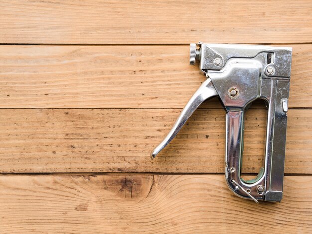 Steel staple gun on table