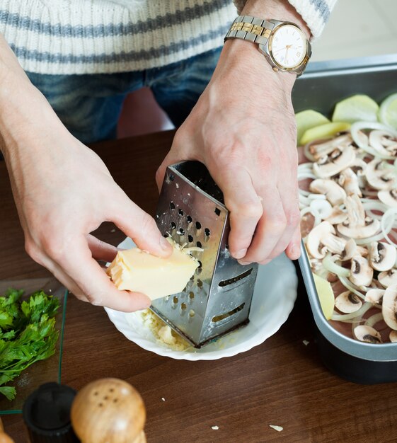 Steps of cooking french-style meat. Greating cheese