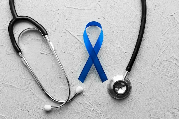 Free photo stethoscope around colon cancer ribbon